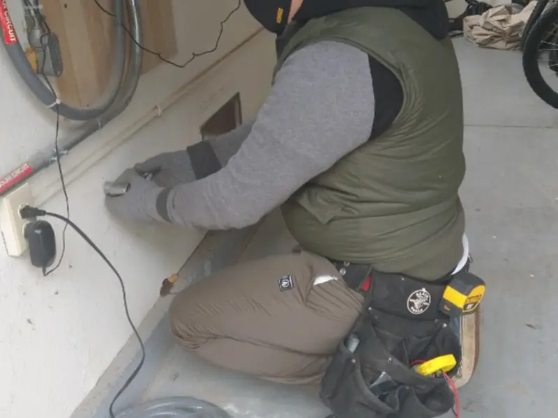 Electrician performing outlet wiring in a Druid Hills garage