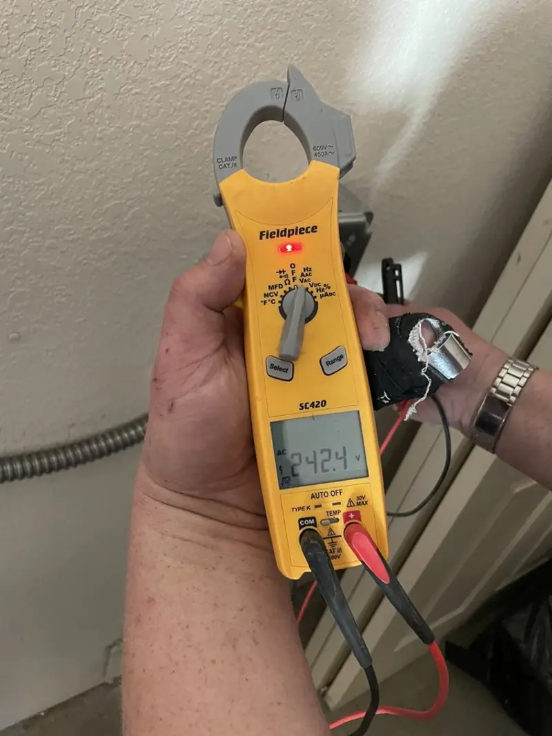 Voltage testing with clamp meter during Outlet Installation in Druid Hills